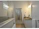 Elegant bathroom showcasing a glass shower, granite countertop, and neutral color palette at 1057 Castle Pines Ct, Reunion, FL 34747