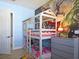 Themed bedroom with bunk beds, comic-themed rug, and play area at 1057 Castle Pines Ct, Reunion, FL 34747
