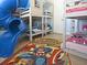 This bright and playful bedroom includes bunk beds and a colorful comic-themed rug at 1057 Castle Pines Ct, Reunion, FL 34747