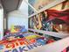 A close-up view of a themed bunk bed with fun bedding and graphics at 1057 Castle Pines Ct, Reunion, FL 34747