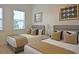 Bright bedroom featuring two beds, two windows, and neutral decor at 1057 Castle Pines Ct, Reunion, FL 34747