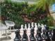 Outdoor chess area featuring oversized chess pieces and tropical landscaping at 1057 Castle Pines Ct, Reunion, FL 34747
