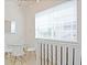 Cozy dining area with modern light fixture, glass table, and natural light at 1057 Castle Pines Ct, Reunion, FL 34747