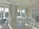 Dining room featuring a glass table with stylish chairs and large windows overlooking the outdoor pool at 1057 Castle Pines Ct, Reunion, FL 34747