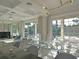 Dining room with a glass table set for a meal, and sliding glass doors showcasing the outside greenery at 1057 Castle Pines Ct, Reunion, FL 34747
