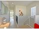Bright hallway with neutral tones, desk and staircase, leading to other areas of the home at 1057 Castle Pines Ct, Reunion, FL 34747