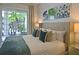 Comfortable main bedroom featuring large windows, a plush king bed, and a serene decor at 1057 Castle Pines Ct, Reunion, FL 34747