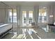 Bright main bedroom features a four-poster bed, sitting area, and a view of the outdoor area at 1057 Castle Pines Ct, Reunion, FL 34747