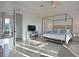 Luxury main bedroom featuring a four-poster bed, sitting area, and private balcony access at 1057 Castle Pines Ct, Reunion, FL 34747