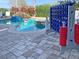 Outdoor swimming pool and patio area, complete with a rock waterfall and fun game at 1057 Castle Pines Ct, Reunion, FL 34747