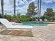 View of outdoor pool and hot tub, accompanied by seating and landscaping at 1057 Castle Pines Ct, Reunion, FL 34747