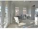 Bright sitting room with neutral decor, a glass coffee table, and access to a balcony at 1057 Castle Pines Ct, Reunion, FL 34747