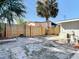 Fenced backyard with mature palm trees and brick paver patio provides privacy and a blank canvas for outdoor living and landscaping at 1085 Whitewood Dr, Deltona, FL 32725