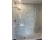 Shower stall has white marbled tiles, and a gray-tiled floor at 1085 Whitewood Dr, Deltona, FL 32725