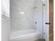 Stylish bathroom featuring a new tub with marble-look tiled walls and updated fixtures at 1085 Whitewood Dr, Deltona, FL 32725