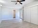 Bright bedroom with light wood floors, ceiling fan, ensuite bathroom and double closet at 1085 Whitewood Dr, Deltona, FL 32725