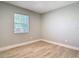 Cozy bedroom featuring a sunny window, neutral paint, and modern wood-look flooring at 1085 Whitewood Dr, Deltona, FL 32725