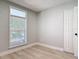 Bedroom with light wood floors, a window, and a closet at 1085 Whitewood Dr, Deltona, FL 32725