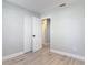 Bedroom with light wood floors and a closet leading to another room at 1085 Whitewood Dr, Deltona, FL 32725