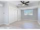 Bright bedroom with light wood floors, ceiling fan, double closet and window at 1085 Whitewood Dr, Deltona, FL 32725