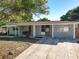 Charming single-story home with stone accents, well-maintained lawn, and inviting curb appeal on a bright, sunny day at 1085 Whitewood Dr, Deltona, FL 32725