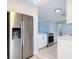 Modern kitchen with stainless steel appliances, white cabinets, and light countertops offers a clean and efficient cooking space at 1085 Whitewood Dr, Deltona, FL 32725