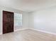 Bright living room with new gray vinyl floors, fresh paint, and a stylish dark wood door, ready for personal touches at 1085 Whitewood Dr, Deltona, FL 32725