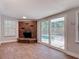 Bright living space boasts tile flooring, a brick fireplace, and sliding doors leading to a pool area, perfect for relaxing at 1085 Whitewood Dr, Deltona, FL 32725