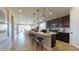 Bright, open-concept space with kitchen island, dining area, and living room with abundant natural light at 1110 Olivine Ave, Dundee, FL 33838
