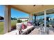Outdoor patio featuring comfortable seating with a view of the well-maintained lawn and blue sky at 1110 Olivine Ave, Dundee, FL 33838