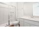 Bathroom featuring white cabinets, shower and quartz counters at 1114 Olivine Ave, Dundee, FL 33838