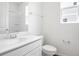 Clean, modern bathroom with white vanity, sink, toilet, and shower at 1114 Olivine Ave, Dundee, FL 33838