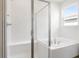 Bathroom features glass enclosed shower and separate soaking tub at 1114 Olivine Ave, Dundee, FL 33838