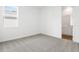 This light and airy bedroom features neutral carpet and an ensuite bath at 1114 Olivine Ave, Dundee, FL 33838