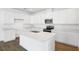 Spacious kitchen with white cabinets, quartz countertops, stainless appliances, and center island at 1114 Olivine Ave, Dundee, FL 33838