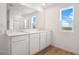 Bathroom features a double vanity with granite countertop and large mirror at 1118 Olivine Ave, Dundee, FL 33838