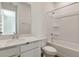 Bathroom features a tub with shower, large mirror, and vanity with granite countertop at 1118 Olivine Ave, Dundee, FL 33838