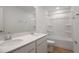 Bathroom features a double vanity, mirror, and tub with shower at 1118 Olivine Ave, Dundee, FL 33838