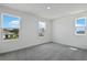 Bedroom with three windows offers ample natural light and views of the community at 1118 Olivine Ave, Dundee, FL 33838