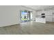 Open concept living space featuring neutral wall colors, wood-look tile flooring, and large sliding doors to backyard at 1118 Olivine Ave, Dundee, FL 33838