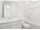 Bright bathroom featuring a tub, shower, single sink, and white cabinets at 1130 Olivine Ave, Dundee, FL 33838