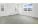 Bright bedroom featuring neutral colors, tile floors, and lots of natural light at 1130 Olivine Ave, Dundee, FL 33838