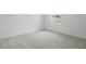 Bedroom featuring a view of the neighborhood, neutral carpet, and light walls at 1130 Olivine Ave, Dundee, FL 33838