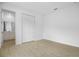 Bedroom with tile floors leading to a bathroom with a white vanity and cabinets at 1130 Olivine Ave, Dundee, FL 33838