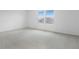 Bright bedroom with a view, featuring neutral carpet and light walls at 1130 Olivine Ave, Dundee, FL 33838