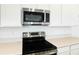 Stainless steel appliances are a highlight of the kitchen, showcasing the microwave and stovetop at 1130 Olivine Ave, Dundee, FL 33838
