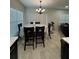 Inviting dining room with modern chandelier and large windows providing natural light at 12 E Murphy E St, Davenport, FL 33837