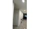 The bright hallway features plant accents, tile floors, and neutral paint scheme at 12 E Murphy E St, Davenport, FL 33837