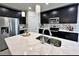 Modern kitchen featuring stainless steel appliances, black cabinets, and a marble countertop at 12 E Murphy E St, Davenport, FL 33837