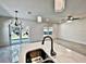 Open concept kitchen with marble island, stainless steel sink, and view into the living area at 12 E Murphy E St, Davenport, FL 33837